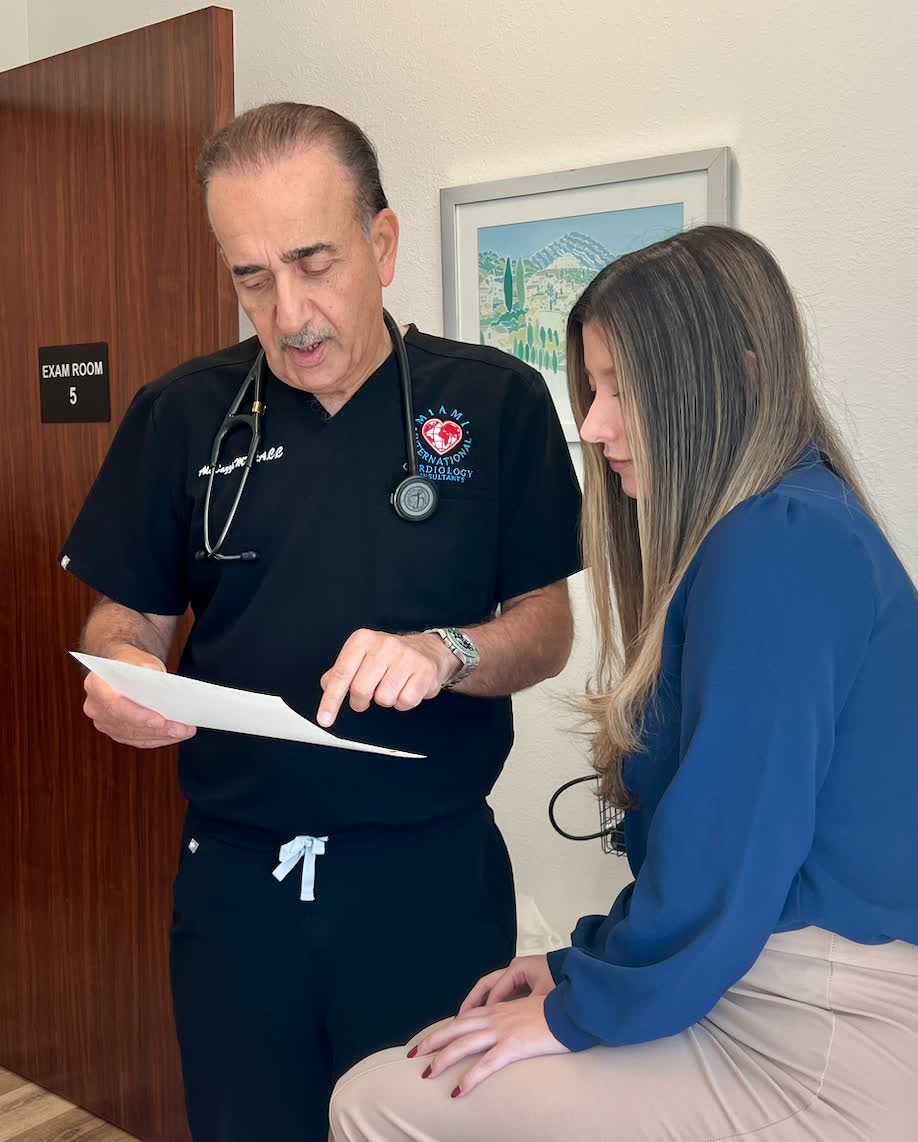 Dr. Bazzi reviewing a document in the exam room